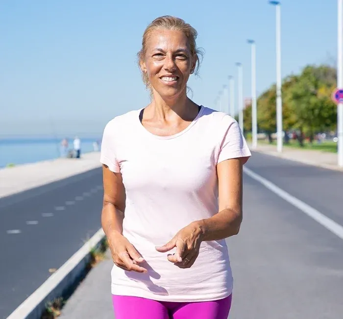 A woman walking on a waterfront path